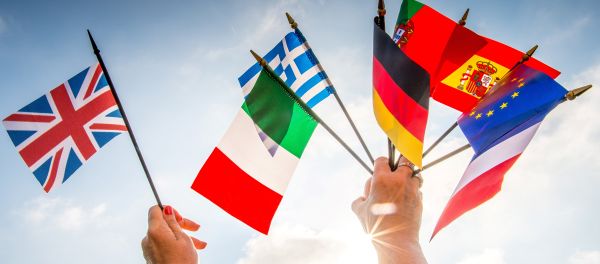A person holds European country flags in an hand and a United Kingdom flag in another. A person holds European country flags in an hand and a United Kingdom flag in another. - Sputnik International