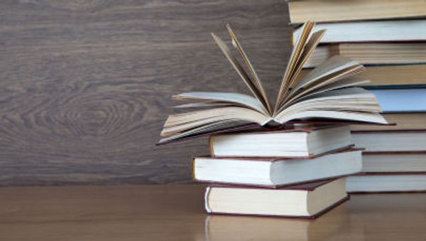 Books on wooden deck tabletop. - Sputnik International
