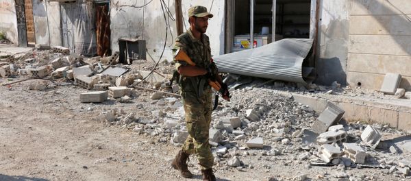 A member of Turkish-backed Free Syrian Army (FSA) patrols in the border town of Jarablus, Syria A member of Turkish-backed Free Syrian Army (FSA) patrols in the border town of Jarablus, Syria - Sputnik International