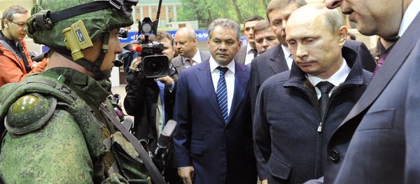 Russian President Vladimir Putin, second left, reviews examples of 'Ratnik' modern military garment during a working visit to OJSC 'Kalashnikov Concern' in Izhevsk. Center - Russian Denfence Minister Sergei Shoigu. Russian President Vladimir Putin, second left, reviews examples of 'Ratnik' modern military garment during a working visit to OJSC 'Kalashnikov Concern' in Izhevsk. Center - Russian Denfence Minister Sergei Shoigu. - Sputnik International