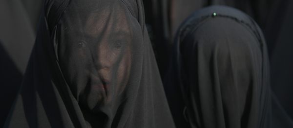 An Iraqi Shiite girl, whose face is covered with a veil, takes part in a parade in preparation for the peak of the mourning period of Ashura in Baghdad's northern district of Kadhimiya on October 22, 2015 An Iraqi Shiite girl, whose face is covered with a veil, takes part in a parade in preparation for the peak of the mourning period of Ashura in Baghdad's northern district of Kadhimiya on October 22, 2015 - Sputnik International