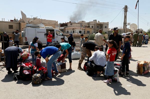 Civilians get their belongings inspected by Syrian Army soldiers in Daraya before being evacuated, after reports of an agreement between rebels and Syria's army to evacuate civilians and rebel fighters from Moadamiya, in Damascus, Syria September 2, 2016 - Sputnik International