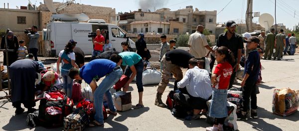 Civilians get their belongings inspected by Syrian Army soldiers in Daraya before being evacuated, after reports of an agreement between rebels and Syria's army to evacuate civilians and rebel fighters from Moadamiya, in Damascus, Syria September 2, 2016 - Sputnik International