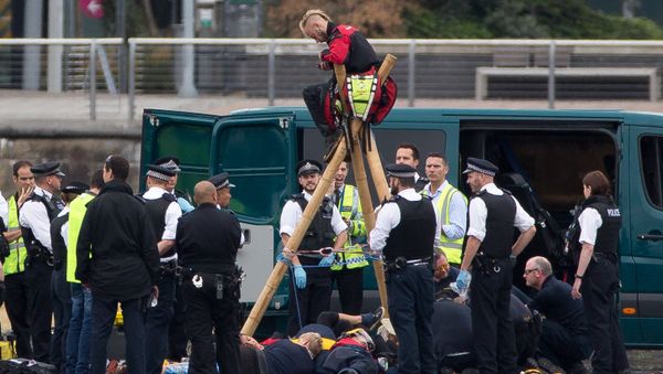 Emergency services surround protestors from the movement Black Lives Matter after they locked themselves to a tripod on the runway at London City Airport in London on September 6, 2016 Emergency services surround protestors from the movement Black Lives Matter after they locked themselves to a tripod on the runway at London City Airport in London on September 6, 2016 - Sputnik International
