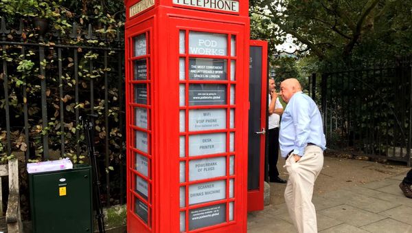 Britain's iconic red public telephone boxes turned into work pods. - Sputnik International