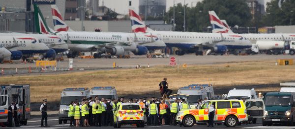 Emergency services surround protestors from the movement Black Lives Matter after they locked themselves to a tripod on the runway at London City Airport in London on September 6, 2016 - Sputnik International