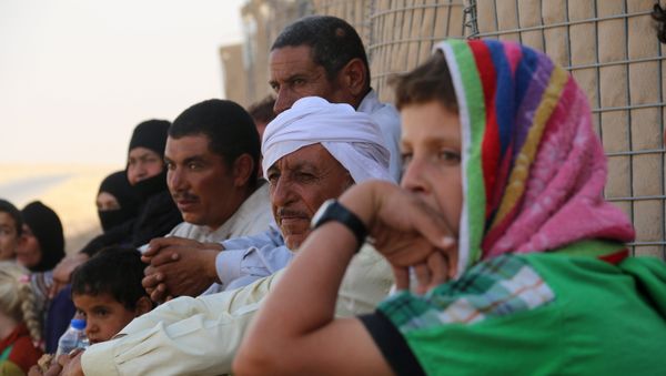 Iraqi families who fled Hawijah in northern Iraq, gather after arriving in the Kirkuk province, about 200 km north of the capital Baghdad, on August 7, 2016 Iraqi families who fled Hawijah in northern Iraq, gather after arriving in the Kirkuk province, about 200 km north of the capital Baghdad, on August 7, 2016 - Sputnik International