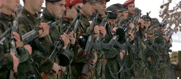 A Kosovo Liberation Army (UCK) honor guard stands at attention at the funeral in southwestern Kosovo near Pec and Djakovica for five of 24 Kosovars slain in an ambush in Rogovo last week by Serbian Interior Ministry forces. A Kosovo Liberation Army (UCK) honor guard stands at attention at the funeral in southwestern Kosovo near Pec and Djakovica for five of 24 Kosovars slain in an ambush in Rogovo last week by Serbian Interior Ministry forces. - Sputnik International