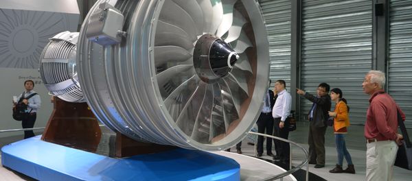 This file photo taken on November 7, 2013 shows visitors looking at a full-size model of an aircraft jet engine made by China Aviation Industry Corporation at the China International Industry Fair in Shanghai - Sputnik International