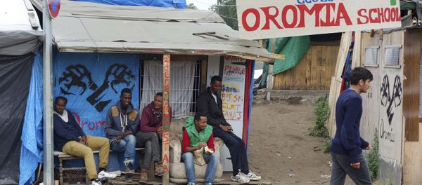 Migrants stand under makeshift shelters in the northern area of the camp called the Jungle in Calais, France, September 6, 2016 - Sputnik International