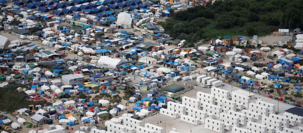 Aerial view of a makeshift camp as containers (front) are put into place to house migrants living in what is known as the Jungle, a sprawling camp in Calais, France, August 14, 2016 Aerial view of a makeshift camp as containers (front) are put into place to house migrants living in what is known as the Jungle, a sprawling camp in Calais, France, August 14, 2016 - Sputnik International