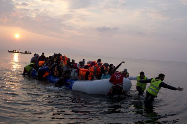  In this Sunday, March 20, 2016 file photo, volunteers help migrants and refugees on a dingy as they arrive at the shore of the northeastern Greek island of Lesbos, after crossing the Aegean sea from Turkey. - Sputnik International