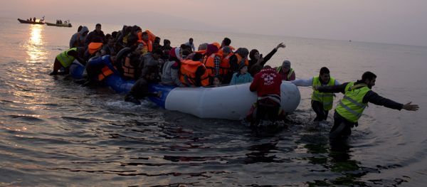 In this Sunday, March 20, 2016 file photo, volunteers help migrants and refugees on a dingy as they arrive at the shore of the northeastern Greek island of Lesbos, after crossing the Aegean sea from Turkey. In this Sunday, March 20, 2016 file photo, volunteers help migrants and refugees on a dingy as they arrive at the shore of the northeastern Greek island of Lesbos, after crossing the Aegean sea from Turkey. - Sputnik International