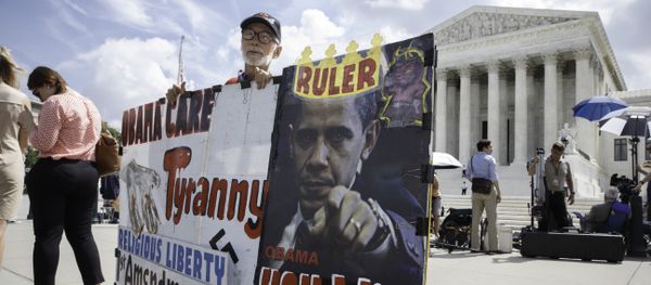 Ronald Brock moves his anti-Obamacare sign as protestors, press, and passersby wait for decisions in the final days of the Supreme Court's term, in Washington, Wednesday, June 25, 2014 Ronald Brock moves his anti-Obamacare sign as protestors, press, and passersby wait for decisions in the final days of the Supreme Court's term, in Washington, Wednesday, June 25, 2014 - Sputnik International