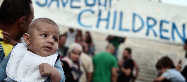 This file photo taken on September 02, 2016 shows refugees with their children protesting if front of the Greek parliament in Athens, calling for faster relocation program and opening of the borders. This file photo taken on September 02, 2016 shows refugees with their children protesting if front of the Greek parliament in Athens, calling for faster relocation program and opening of the borders. - Sputnik International