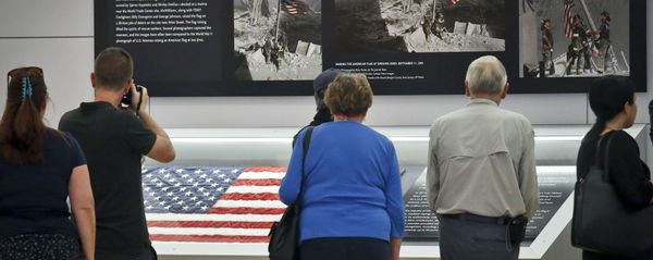 Visitors view the display for the American flag, left, that firefighters hoisted at ground zero in the hours after the 9/11 terror attack at the Sept. 11 museum in New York Visitors view the display for the American flag, left, that firefighters hoisted at ground zero in the hours after the 9/11 terror attack at the Sept. 11 museum in New York - Sputnik International