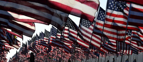 People walk amongst US national flags erected by students and staff from Pepperdine University as they pay their respects to honor the victims of the September 11, 2001 attacks in New York, at their campus in Malibu, California - Sputnik International