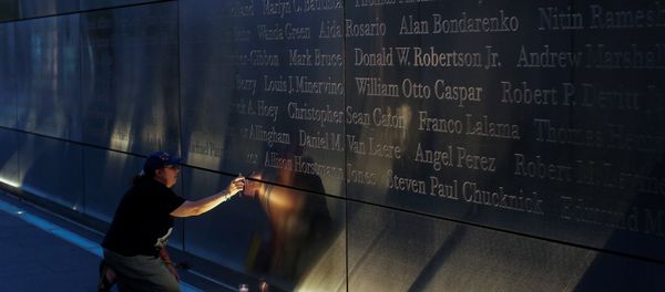 A mourner places a flag in the Empty Sky memorial on the morning of the 15th anniversary of the 9/11 attacks in New Jersey, U.S A mourner places a flag in the Empty Sky memorial on the morning of the 15th anniversary of the 9/11 attacks in New Jersey, U.S - Sputnik International