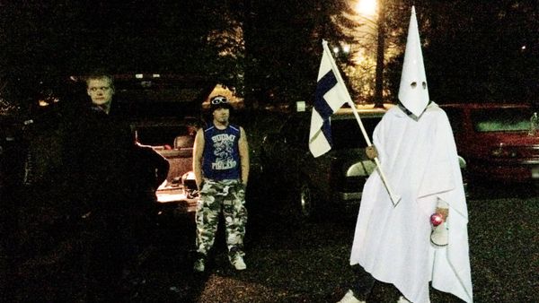 Sept. 24, 2015 photo, a group of demonstrators including one wearing an outfit in the style of the Ku Klux Klan stand in protest against refugees near a former army barracks in Hennala district in Lahti, Finland. Sept. 24, 2015 photo, a group of demonstrators including one wearing an outfit in the style of the Ku Klux Klan stand in protest against refugees near a former army barracks in Hennala district in Lahti, Finland. - Sputnik International