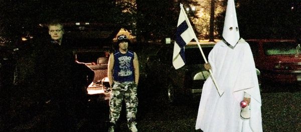 Sept. 24, 2015 photo, a group of demonstrators including one wearing an outfit in the style of the Ku Klux Klan stand in protest against refugees near a former army barracks in Hennala district in Lahti, Finland. - Sputnik International