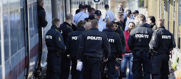 Danish police guards a train with migrants, mainly from Syria and Iraq, at Rodby railway station, southern Denmark Danish police guards a train with migrants, mainly from Syria and Iraq, at Rodby railway station, southern Denmark - Sputnik International