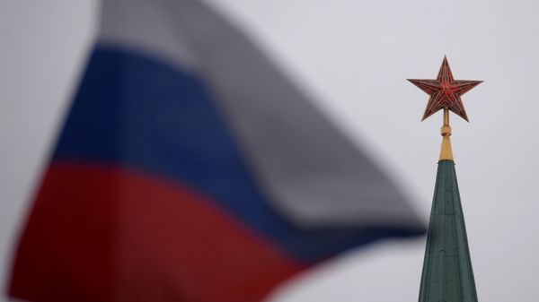 A spire of a Moscow Kremlin tower and a Russian flag on Red Square A spire of a Moscow Kremlin tower and a Russian flag on Red Square - Sputnik International