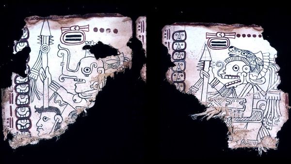 (L) The enigmatic God K, the so-called Long-nosed God, brandishes a spear with a large point, below which are placed smaller transverse points with red bases. (R) The Death God stands with a similar spear. - Sputnik International