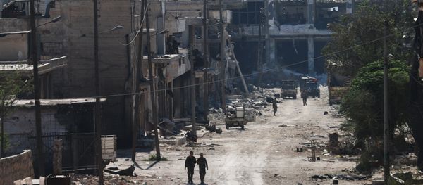 Syrian pro-regime fighters walk in a bombed-out steet in Ramussa on September 9, 2016, after they took control of the strategically important district on the outskirts of the Syrian city of Aleppo yesterday - Sputnik International