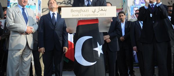 Britain's Prime Minister David Cameron addresses the gathering from a podium decked with the National Transitional Council's (NTC) adopted flag in Benghazi on September 15, 2011. - Sputnik International