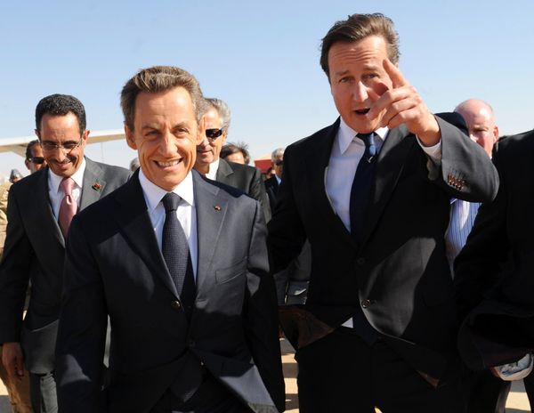 Then British Prime Minister David Cameron (R) gestures next to then French President Nicholas Sarkozy as they arrive at Benghazi airport on September 15, 2011.  - Sputnik International