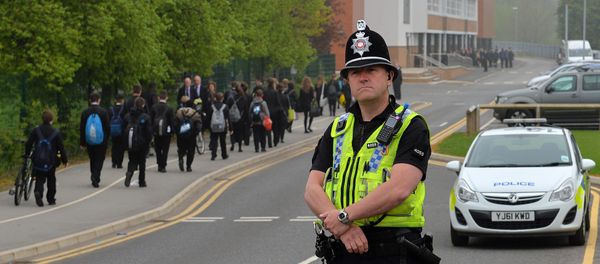 A police officer stands at Corpus Christi Catholic College in Leeds, northern England on April 29, 2014 - Sputnik International