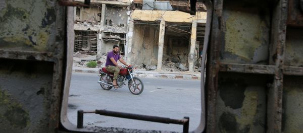 A man rides a motocycle near damaged buildings in the rebel held Old Aleppo, Syria, September 14, 2016 A man rides a motocycle near damaged buildings in the rebel held Old Aleppo, Syria, September 14, 2016 - Sputnik International