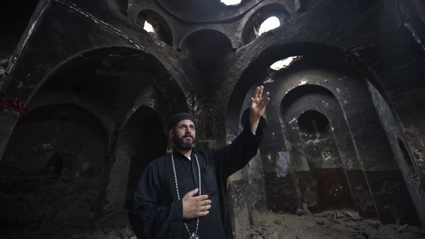Delga's Coptic priest Yuannas points at the damage in the historical Blessed Virgin church following an attack by masked Islamist men the previous month in the town of Delga, in the central Egyptian province of Minya, some of 400 kilometres south of Cairo, on September 29, 2013 Delga's Coptic priest Yuannas points at the damage in the historical Blessed Virgin church following an attack by masked Islamist men the previous month in the town of Delga, in the central Egyptian province of Minya, some of 400 kilometres south of Cairo, on September 29, 2013 - Sputnik International