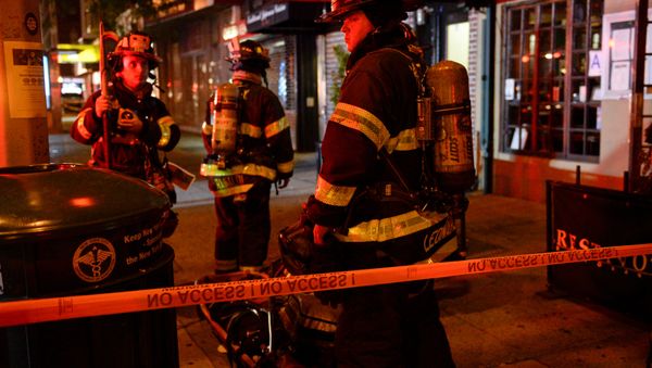 New York City firefighters stand near the site of an explosion in the Chelsea neighborhood of Manhattan, New York, U.S. September 18, 2016. - Sputnik International