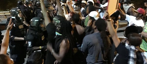 Protestors demonstrate in front of police officers wearing riot gear after police fatally shot Keith Lamont Scott in the parking lot of an apartment complex in Charlotte, North Carolina, U.S. September 20, 2016 - Sputnik International