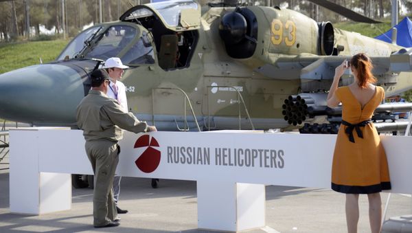 A woman as she takes a photo of a Russian military helicopter KA-52 at the ADEX 2014 International Defence Industry Exhibition in Baku on September 11, 2014 A woman as she takes a photo of a Russian military helicopter KA-52 at the ADEX 2014 International Defence Industry Exhibition in Baku on September 11, 2014 - Sputnik International