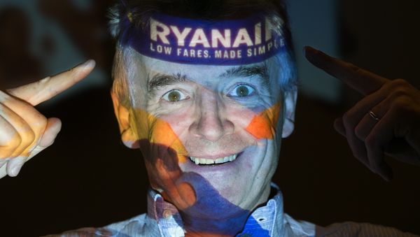 Chief Executive Officer of Irish airline Ryanair Michael O'Leary poses with his company's logo projected on his face as he attends a press conference at a hotel in London on August 31, 2016. - Sputnik International