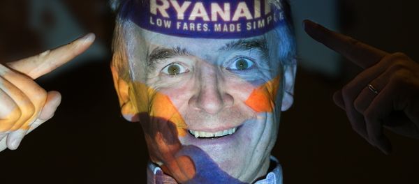 Chief Executive Officer of Irish airline Ryanair Michael O'Leary poses with his company's logo projected on his face as he attends a press conference at a hotel in London on August 31, 2016. - Sputnik International