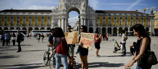 People hold posters welcoming refugees during a rally in support of migrants and refugees as part of the European Day of Action in Lisbon (File) People hold posters welcoming refugees during a rally in support of migrants and refugees as part of the European Day of Action in Lisbon (File) - Sputnik International