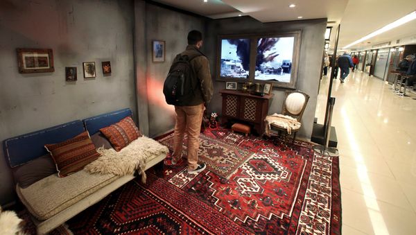 A man stands inside a Syrian house, which is part of an Amnesty International art installation to raise awarness of the conflict in Syria, at a subway station in Buenos Aires, Argentina, September 19, 2016 - Sputnik International