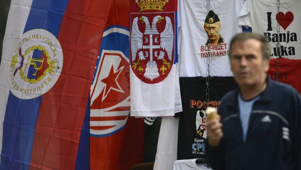 In this photo taken on Wednesday, Sept. 21, 2016. Bosnian man passes by flags of Bosnia's Serb mini state Republic of Srpska and t-shirt with photos of Russian President Vladimir Putin in the Bosnian town of Banja Luka, 240 kms (150 miles) northwest of the Bosnian capital of Sarajevo In this photo taken on Wednesday, Sept. 21, 2016. Bosnian man passes by flags of Bosnia's Serb mini state Republic of Srpska and t-shirt with photos of Russian President Vladimir Putin in the Bosnian town of Banja Luka, 240 kms (150 miles) northwest of the Bosnian capital of Sarajevo - Sputnik International