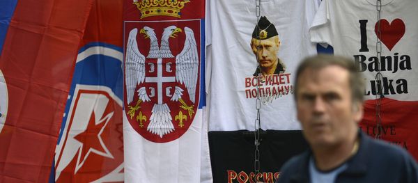 In this photo taken on Wednesday, Sept. 21, 2016. Bosnian man passes by flags of Bosnia's Serb mini state Republic of Srpska and t-shirt with photos of Russian President Vladimir Putin in the Bosnian town of Banja Luka, 240 kms (150 miles) northwest of the Bosnian capital of Sarajevo - Sputnik International