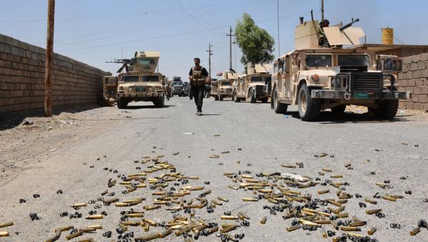 Shell casings lie on the ground as Iraqi government forces gather around the Qayyarah airbase, which was seized by Iraqi forces last week from jihadists of the Islamic State (IS)group, on July 13, 2016, some 60 kilometres (35 miles) south of Mosul Shell casings lie on the ground as Iraqi government forces gather around the Qayyarah airbase, which was seized by Iraqi forces last week from jihadists of the Islamic State (IS)group, on July 13, 2016, some 60 kilometres (35 miles) south of Mosul - Sputnik International