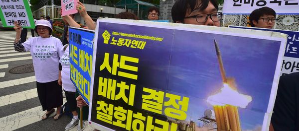 South Korean activists hold placards during a rally against a plan on deployment of the US-built Terminal High Altitude Area Defense (THAAD), outside the Defence Ministry in Seoul on July 13, 2016. Activists have staged a series of rallies voicing their opposition to the missile defense system's deployment in their region. South Korean activists hold placards during a rally against a plan on deployment of the US-built Terminal High Altitude Area Defense (THAAD), outside the Defence Ministry in Seoul on July 13, 2016. Activists have staged a series of rallies voicing their opposition to the missile defense system's deployment in their region. - Sputnik International