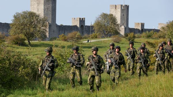 A squad from Skaraborg Armoured Regiment, currently training on the island of Gotland in the Baltic, patrols outside Visby's 13th century city wall, Sweden September 14, 2016 A squad from Skaraborg Armoured Regiment, currently training on the island of Gotland in the Baltic, patrols outside Visby's 13th century city wall, Sweden September 14, 2016 - Sputnik International