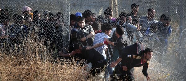 File photo taken from the Turkish side of the border between Turkey and Syria, in Akcakale, Sanliurfa province, southeastern Turkey, Syrian refugees burst into Turkey after breaking the border fence and crossing from Syria cross into Turkey File photo taken from the Turkish side of the border between Turkey and Syria, in Akcakale, Sanliurfa province, southeastern Turkey, Syrian refugees burst into Turkey after breaking the border fence and crossing from Syria cross into Turkey - Sputnik International