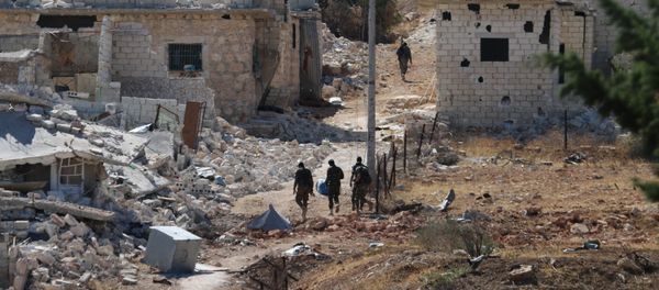 Syrian government forces walk amidst debris in the largely deserted Palestinian refugee camp of Handarat, north of Aleppo. (File) Syrian government forces walk amidst debris in the largely deserted Palestinian refugee camp of Handarat, north of Aleppo. (File) - Sputnik International