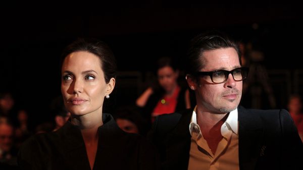This file photo taken on June 13, 2014 shows US actress and special UN envoy Angelina Jolie (L) and her husband US actor Brad Pitt attending the fourth day of the Global Summit to End Sexual Violence in Conflict in London. - Sputnik International