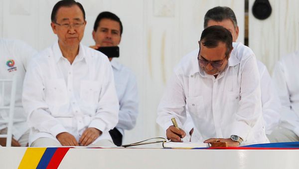 Marxist rebel leader Rodrigo Londono (R), better known by the nom de guerre Timochenko, signs an accord ending a half-century war that killed a quarter of a million people next to United Nations Secretary-General Ban Ki-moon (L), Mexican President Enrique Pena Nieto (2nd L) and Colombian President Juan Manuel Santos (partially obscured) in Cartagena, Colombia September 26, 2016. Marxist rebel leader Rodrigo Londono (R), better known by the nom de guerre Timochenko, signs an accord ending a half-century war that killed a quarter of a million people next to United Nations Secretary-General Ban Ki-moon (L), Mexican President Enrique Pena Nieto (2nd L) and Colombian President Juan Manuel Santos (partially obscured) in Cartagena, Colombia September 26, 2016. - Sputnik International