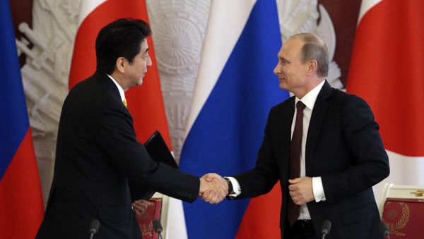 Japanese Prime Minister Shinzo Abe (L) shakes hands with Russian President Vladimir Putin Japanese Prime Minister Shinzo Abe (L) shakes hands with Russian President Vladimir Putin - Sputnik International